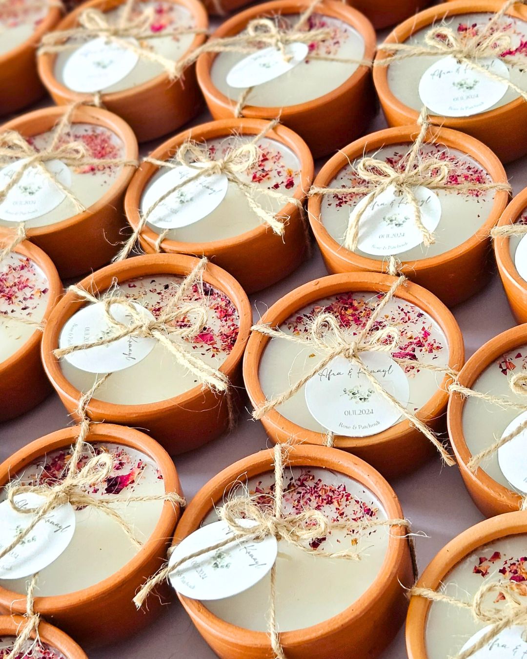 Custom terracotta candles with personalised labels and twine